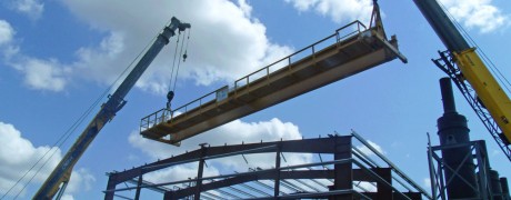 Metal building frame erection using crane